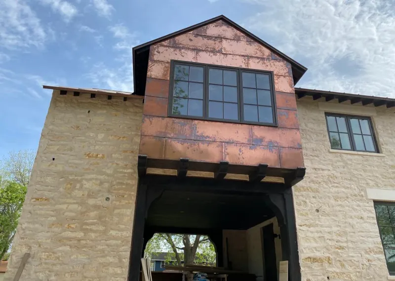 Copper metal panel facade on a stone building for Skylight Installation in Pomfret